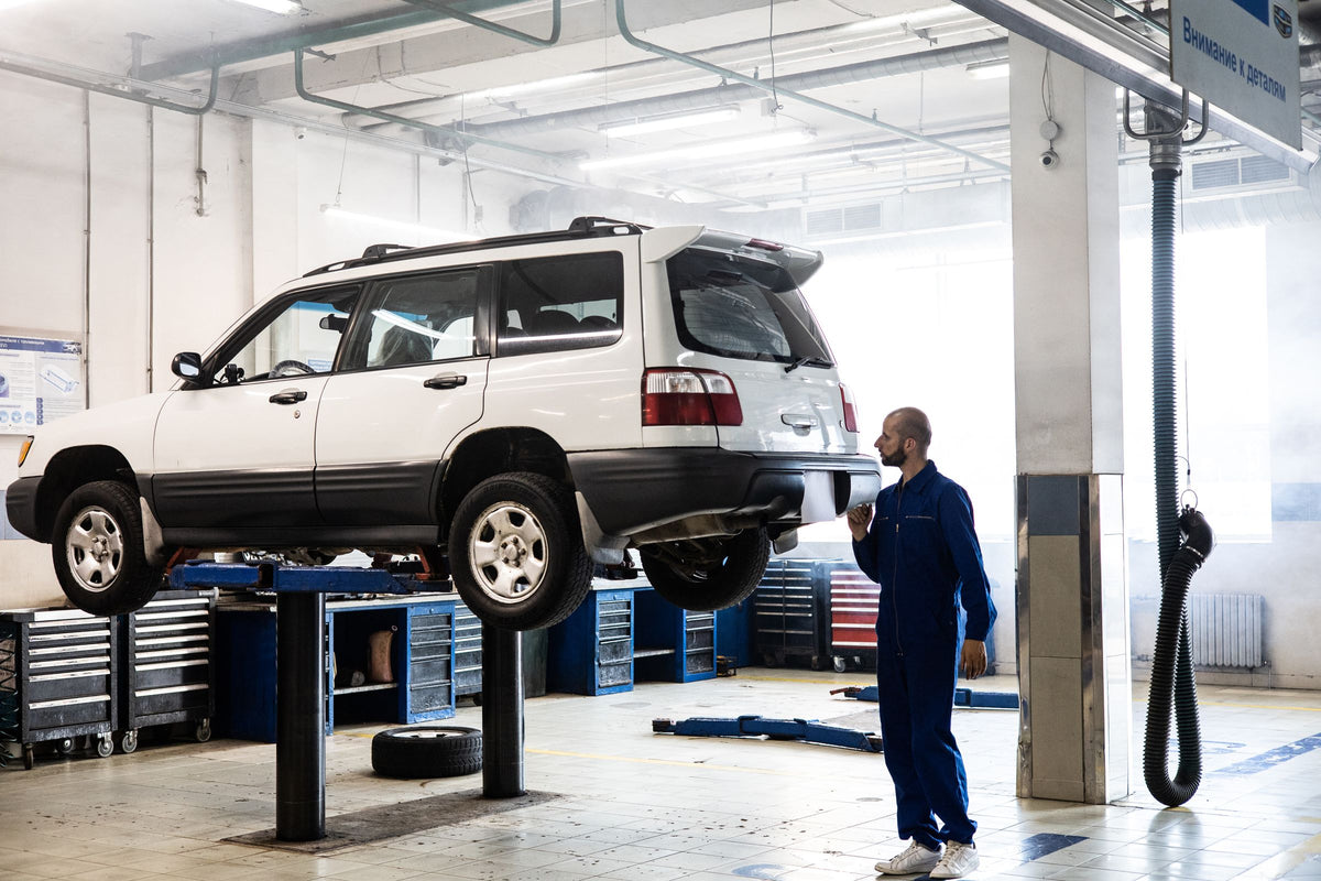 Vehicle raised on a lift in a professional workshop