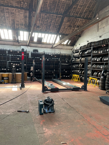 Four post alignment lift installed in a customer tyre workshop