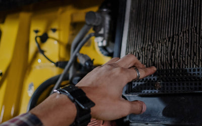 Technician checking a vehicle air conditioning condenser