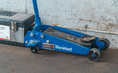 Trolley jack and toolbox on a workshop floor