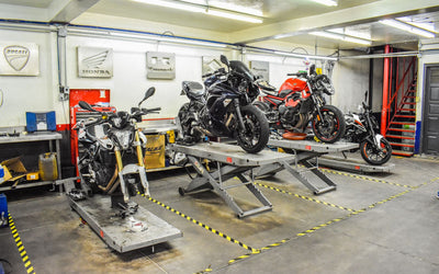 Motorcycles on lift tables in a bike workshop