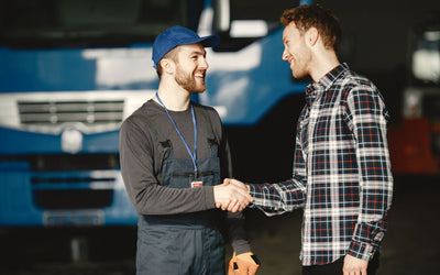 Mechanic shaking hands with a customer