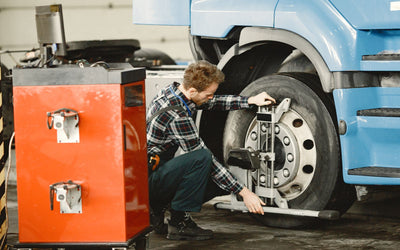 Technician balancing a wheel in a workshop
