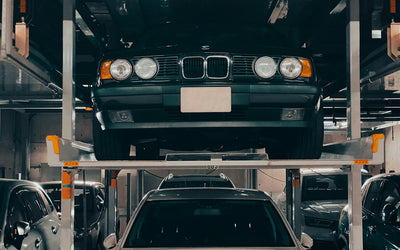 Car stored on a four post lift in a garage